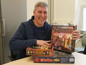 Game fan Michael Reuter with some of the favorites from the FLI Games Night. (Photo: FLI)